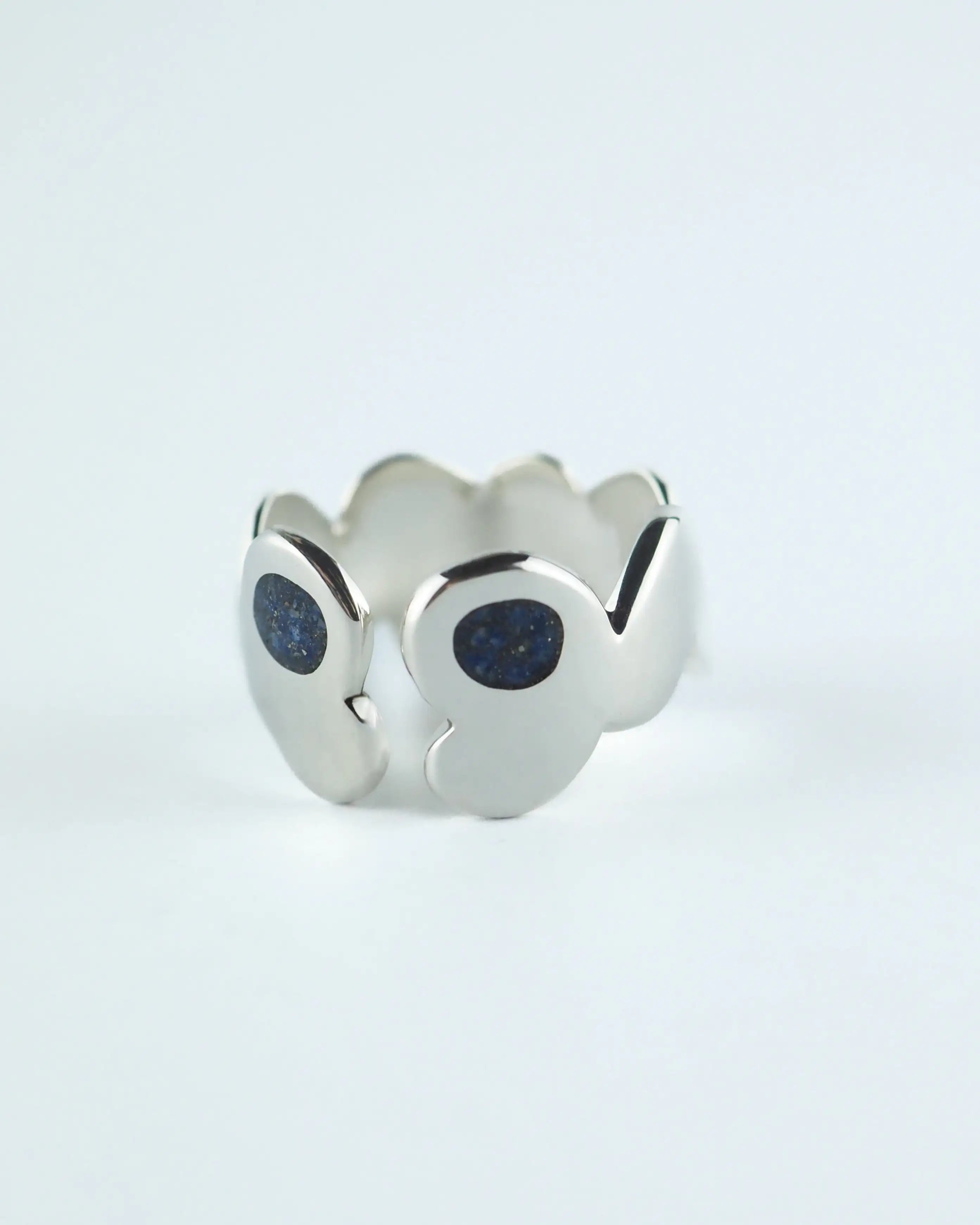 Anillo plateado con piedras azules tipo glitter en el frente